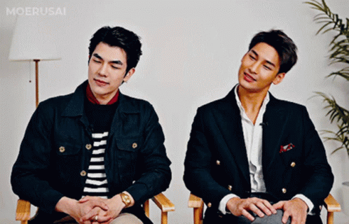 Two Men Sitting Next To Each Other GIF