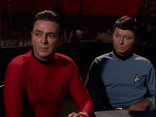 Two Men Sitting Next to Each Other