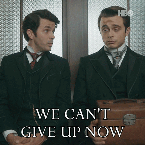 Two Men Sitting Next To Each Other With The Words We Can 'T Give Up Now Behind Them GIF