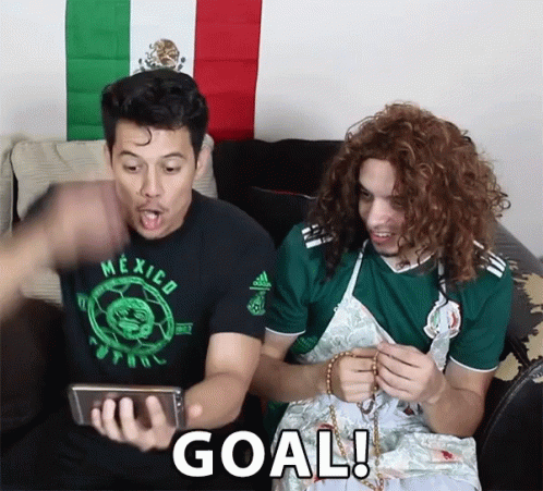 Two Men Sitting On A Couch With One Wearing A Mexico Shirt GIF