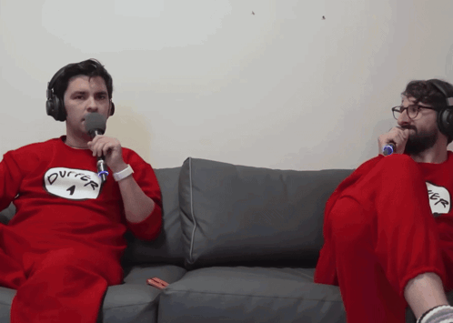 Two Men Sitting On A Couch With One Wearing A Shirt That Says ' Burger ' On It GIF