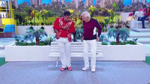 Two Men Sitting On Bench In Garden GIF