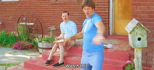Two Men Sitting on Brick Porch Saying Watch This