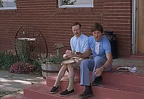 Two Men Sitting on Brick Steps Eating