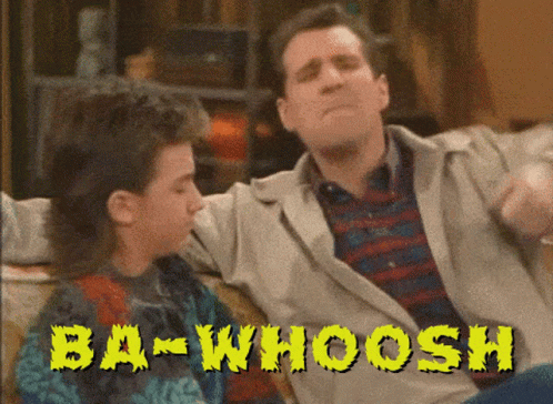 Two Men Sitting on Couch Ba-Whoosh