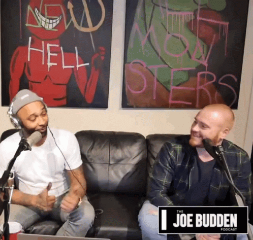 Two Men Sitting on Couch in Front of Joe Budden Sign