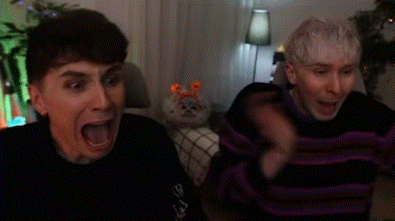 Two Men Sitting on Couch Laughing