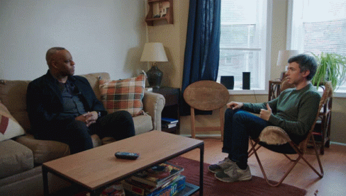 Two Men Sitting On Couch Talking GIF