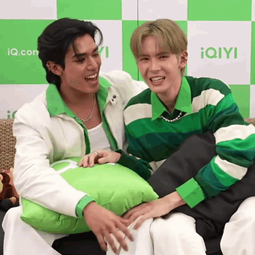 Two Men Sitting One Holding Green Pillow GIF