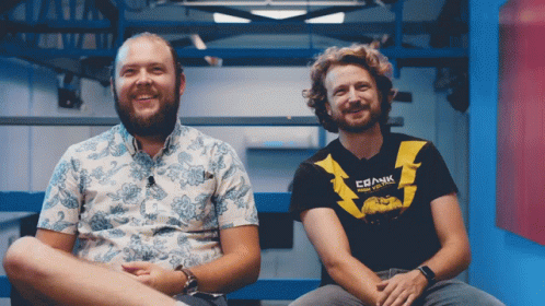 Two Men Sitting, One Shirt Says Crank
