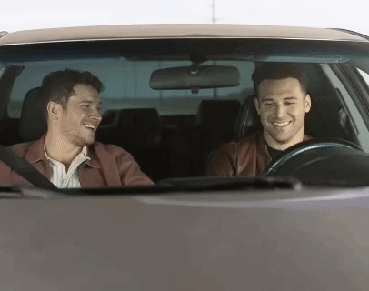 Two Men Smiling and Laughing in Car