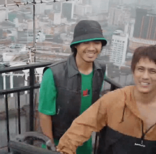 Two Men Smiling on Balcony