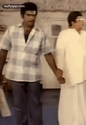 Two Men Standing Holding Hands Talking