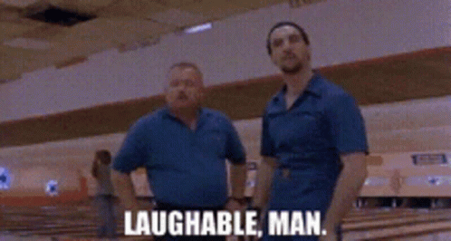 Two Men Standing In A Bowling Alley With The Words Laughable Man Written On The Screen GIF
