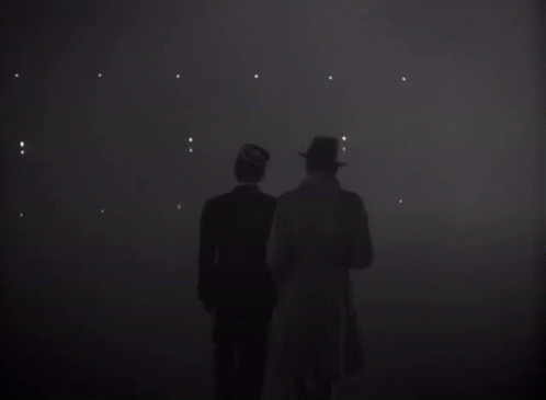 two men standing in a dark room with the word louis on the bottom