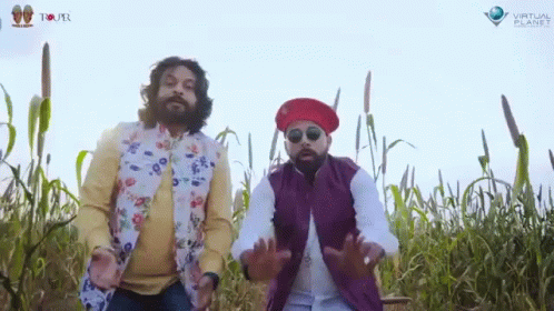 Two Men Standing In A Field With Virtual Planet Written On The Bottom Right GIF