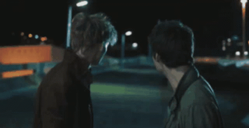 Two Men Standing In Dark Room GIF