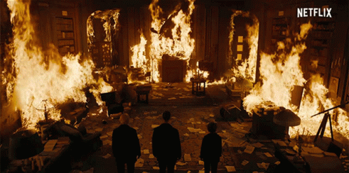 Two Men Standing In Front Of A Burning Room With A Netflix Logo GIF