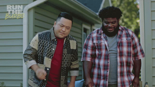Two Men Standing In Front Of A House With The Words Run The Burbs On The Bottom Right GIF