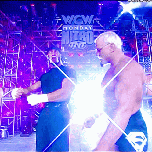 Two Men Standing In Front Of A Sign That Says Wcw Monday Nitro On It GIF