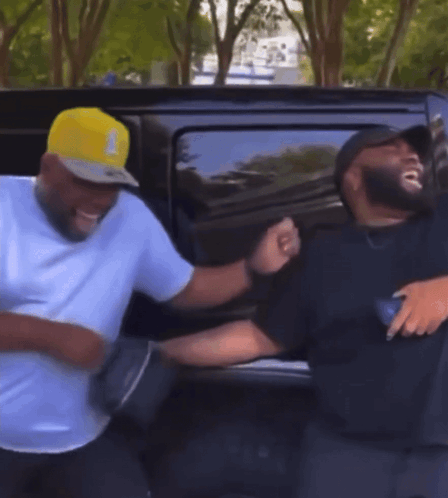 Two Men Standing In Front Of Car GIF