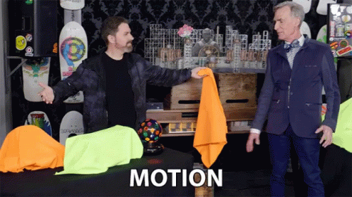 Two Men Standing in Front of Motion Table