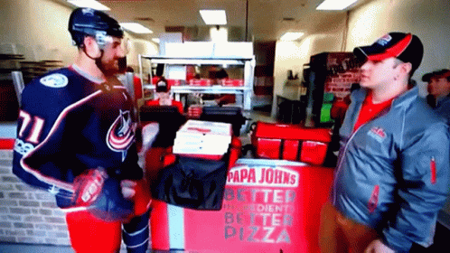 Two Men Standing In Front Of Pizza Box GIF