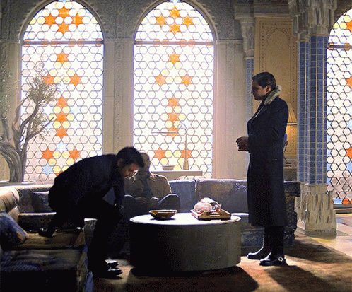 Two Men Standing in Front of Stained Glass Window