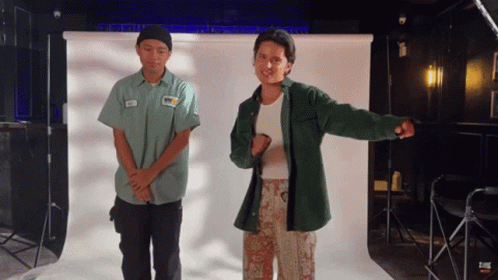 Two Men Standing In Front Of White Background GIF