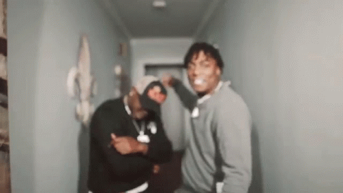 Two Men Standing in Hallway Making Funny Faces
