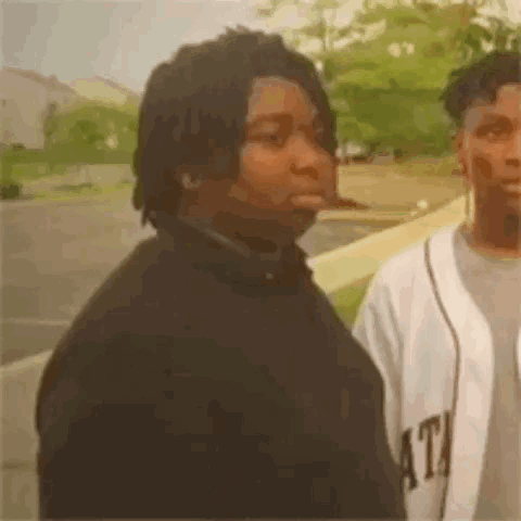 Two Men Standing in Parking Lot