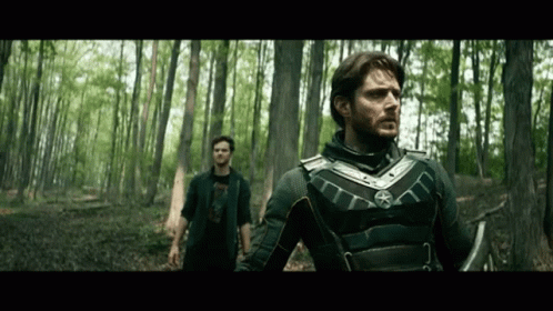 Two Men Standing In Woods Looking GIF