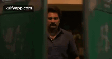 Two Men Standing Near Door GIF