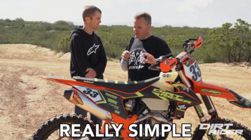 Two Men Standing Next To A Dirt Bike That Says Dirt Rider On It GIF
