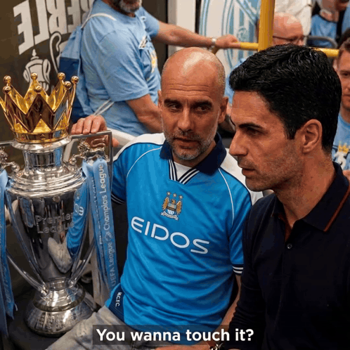 Two Men Standing Next To A Trophy With The Words " You Wanna Touch It " Below Them GIF