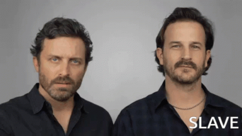 Two Men Standing Next to Each Other