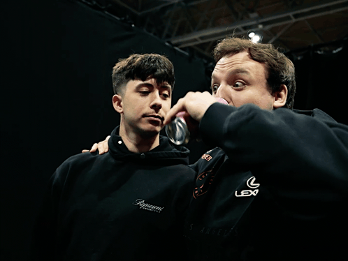 Two Men Standing Next To Each Other GIF
