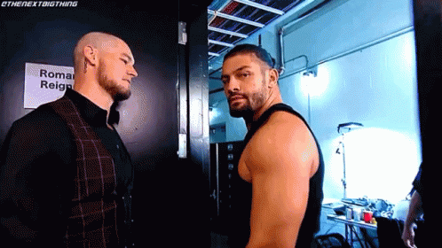 Two Men Standing Next To Each Other GIF