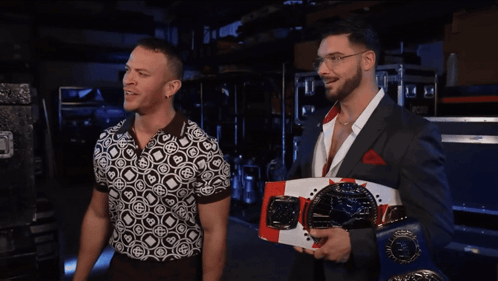 Two Men Standing Next To Each Other GIF