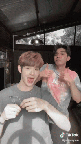 Two Men Standing Next To Each Other GIF