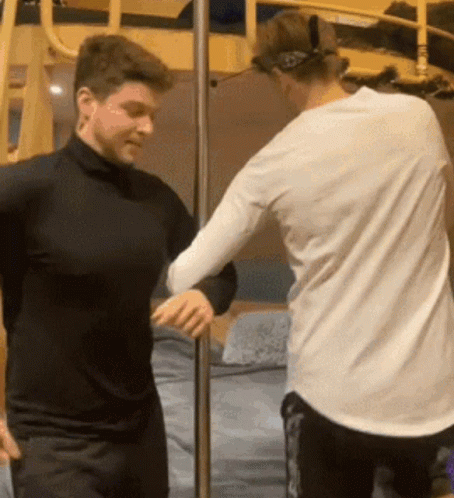 Two Men Standing Next To Each Other GIF