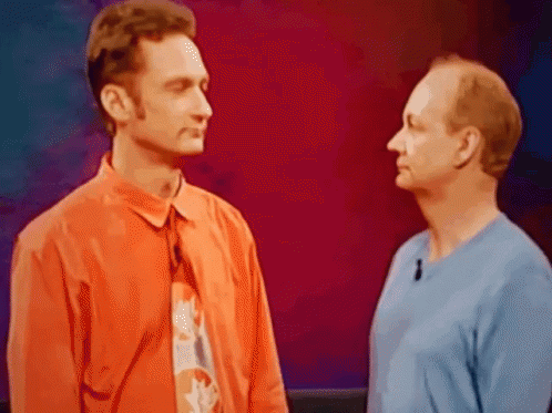 Two Men Standing Next to Each Other