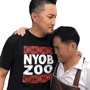 Two Men Standing Next to Each Other