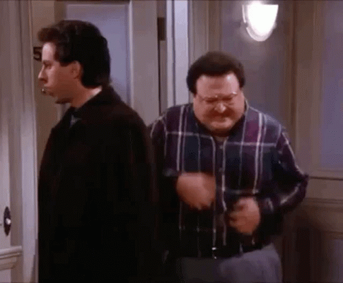 Two Men Standing Next To Each Other, One In Plaid Shirt GIF