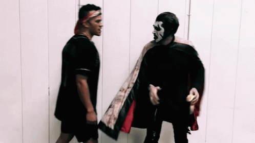 Two Men Standing Next To Each Other GIF
