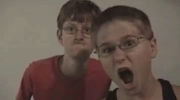 Two Men Standing Next To Each Other Popcorn GIF