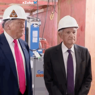 Two Men Standing Next To Each Other Wearing Hard Hats With A Poop On Them GIF
