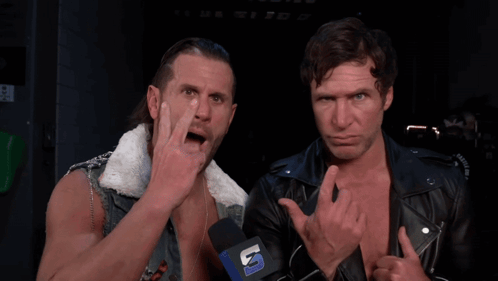 Two Men Standing Next To Each Other With A Microphone That Says U. GIF