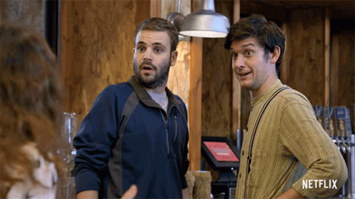 Two Men Standing Next To Each Other With Netflix Logo GIF