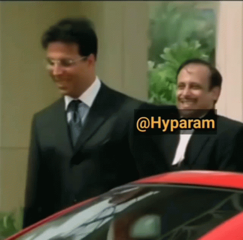Two Men Standing Next To Each Other With A Sticker That Says @Hyparam GIF